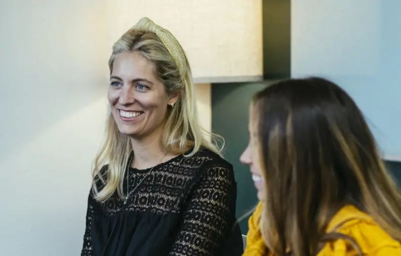two-women-smiling-in-an-office