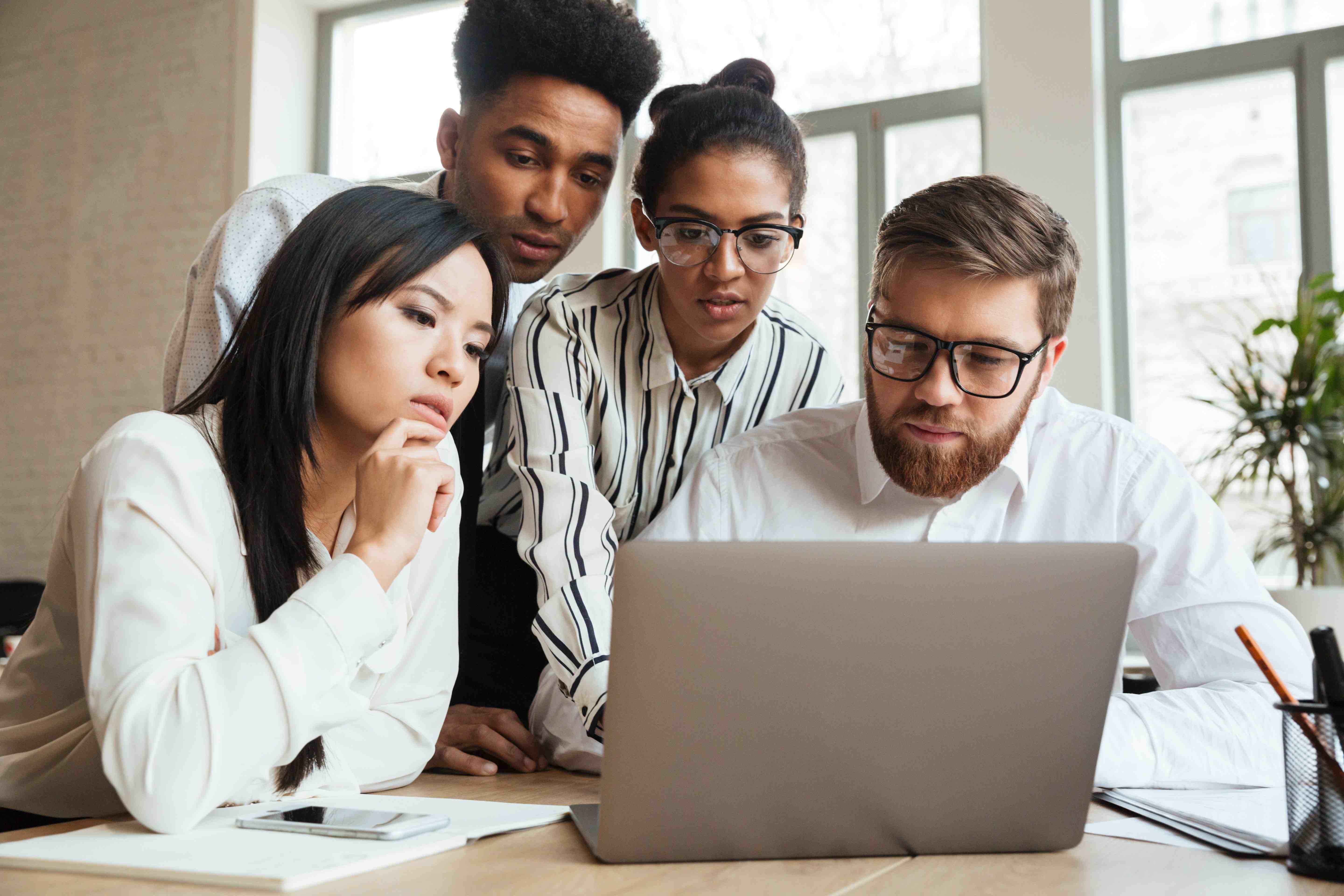 Employees gathered around a computer.