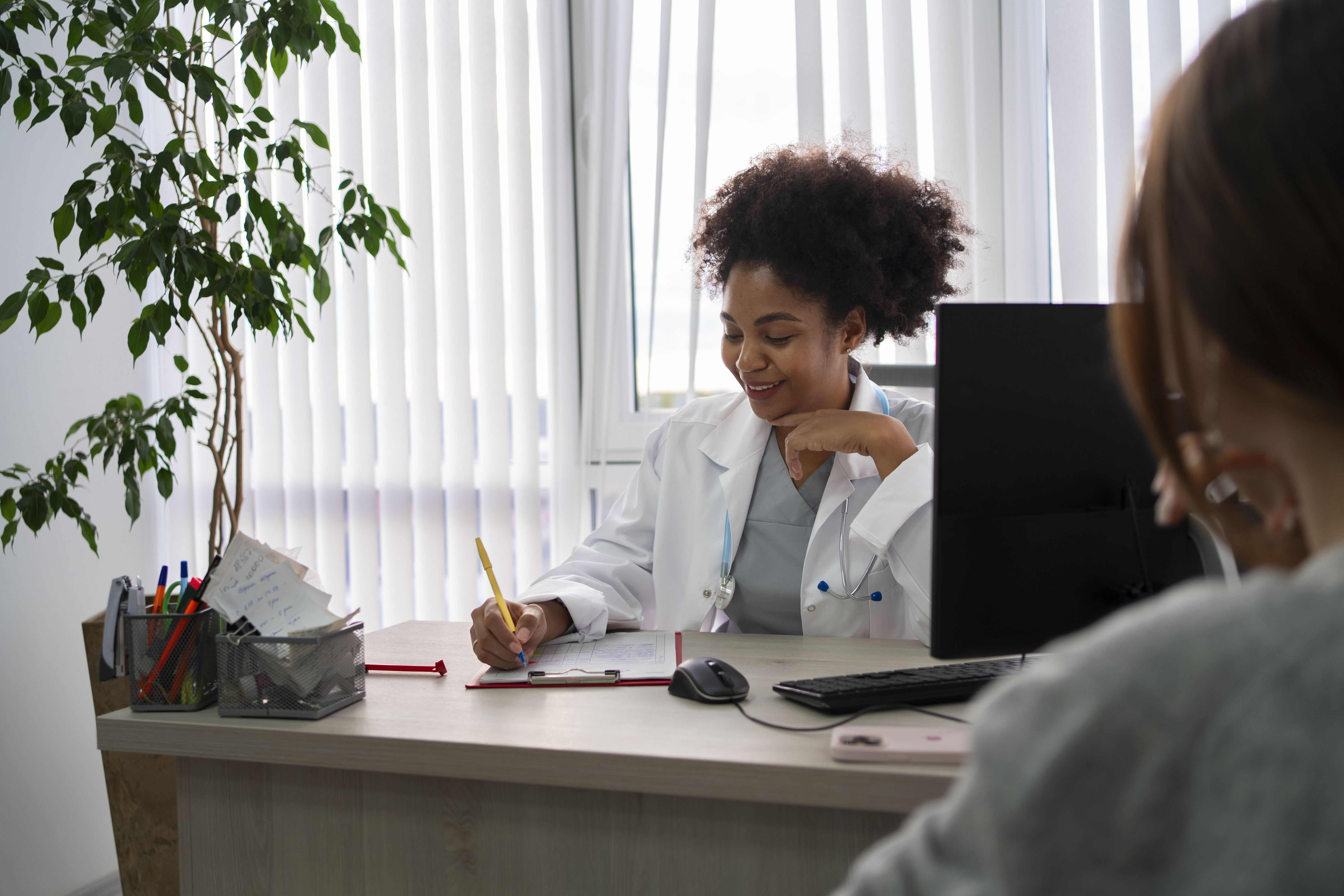 Private practice physician tending to patient.