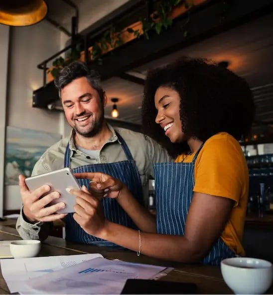 Small business owners working on tablet
