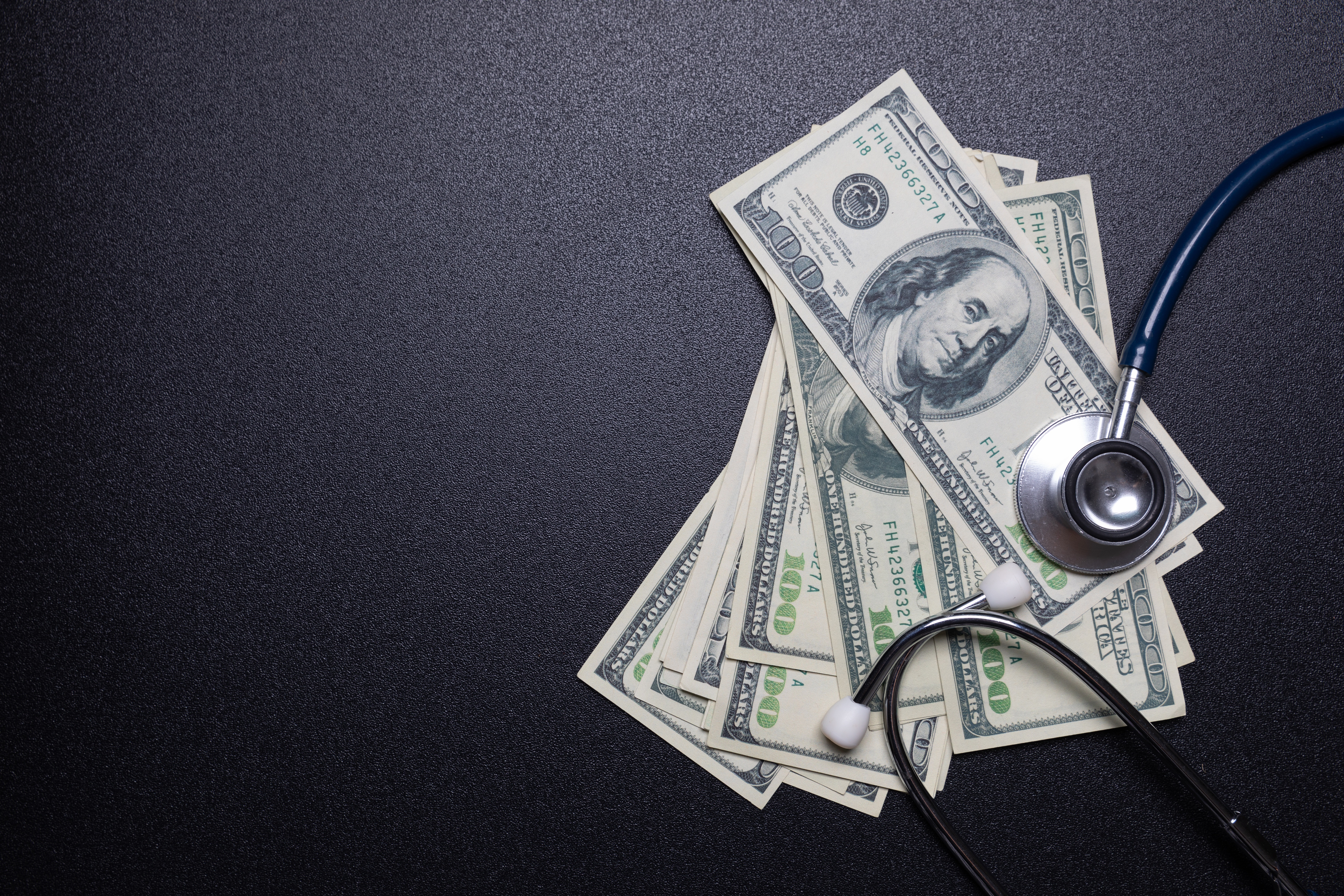 Stethoscope with $100 bills.
