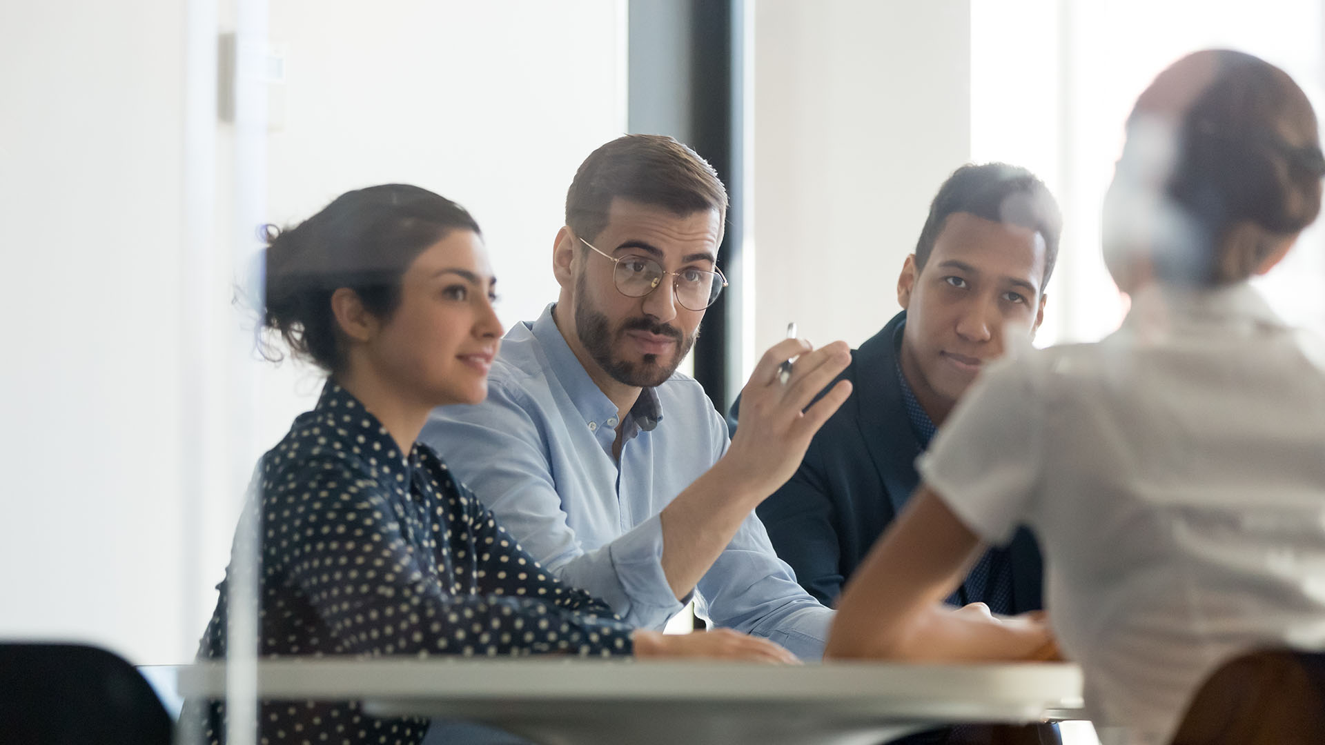 Group of corporate workers talking around a table