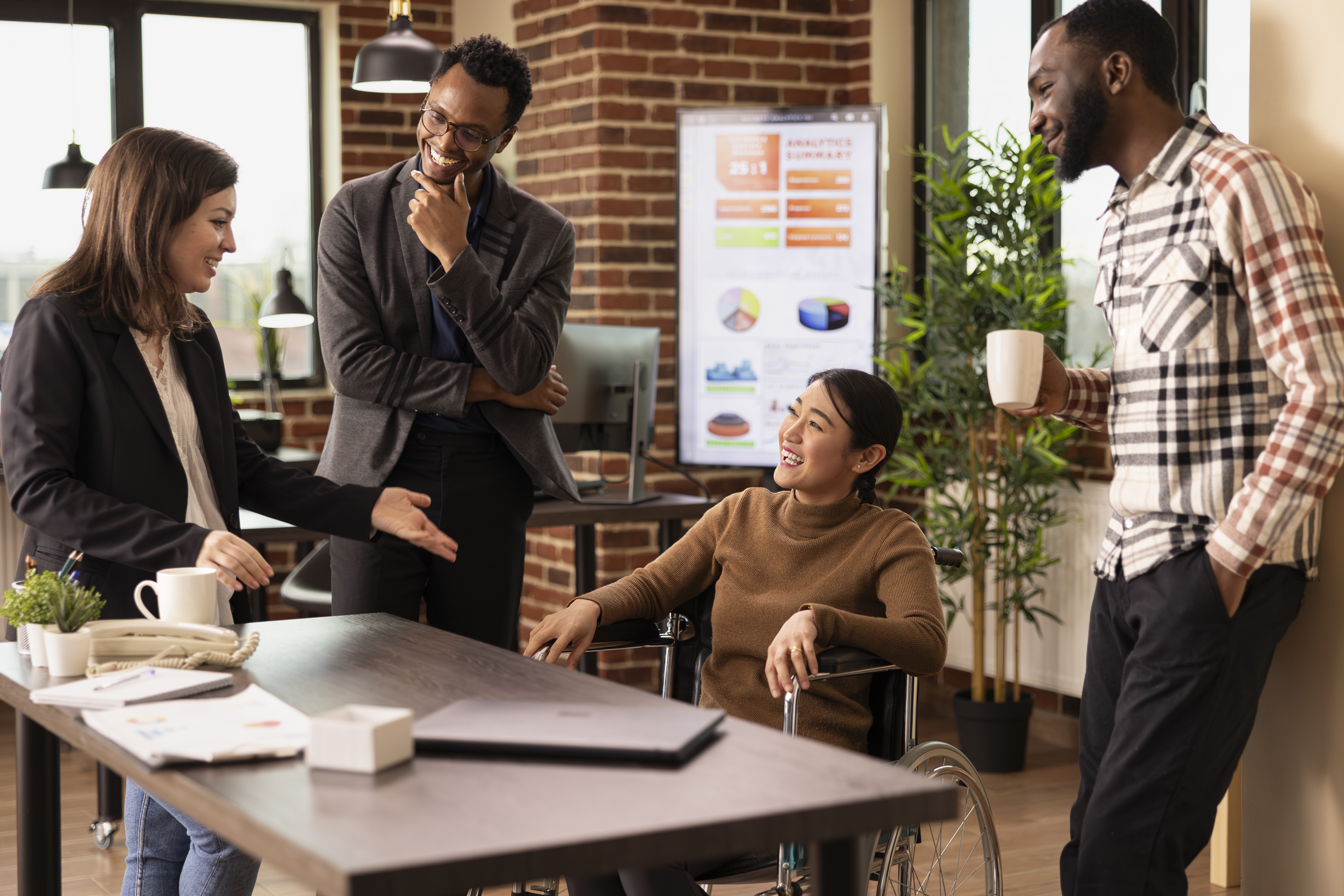 Employees talking around a table.